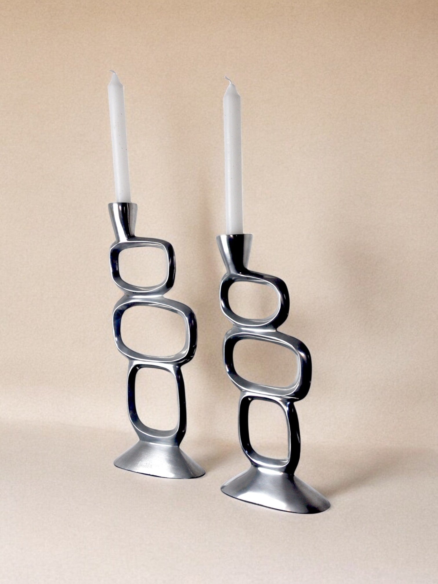 Pair of circle candlesticks by matthew hilton, england, 1980