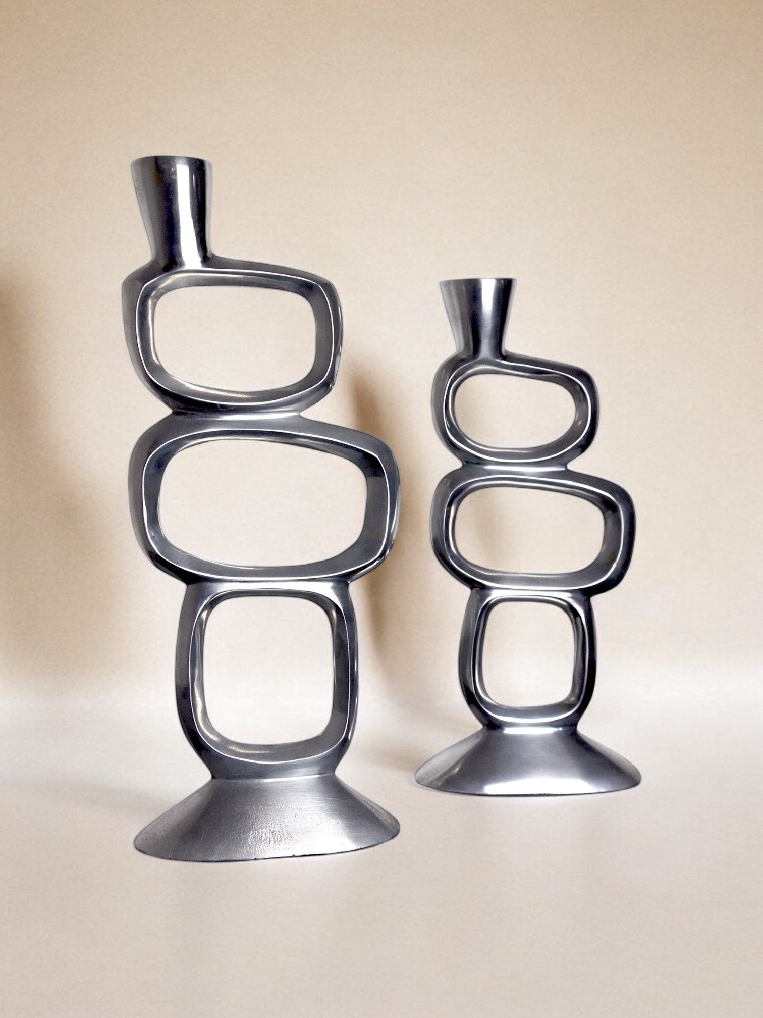 Pair of circle candlesticks by matthew hilton, england, 1980