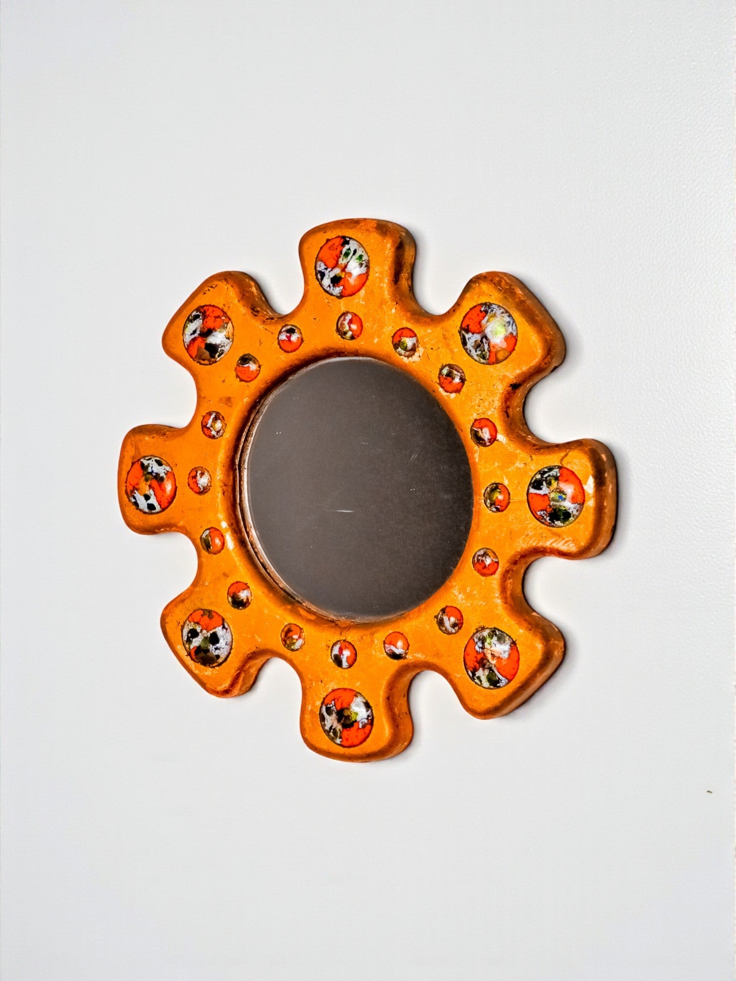 Sun shaped Modernist enamel mirror by J. Capo Esmaltes, Spain, 1970's