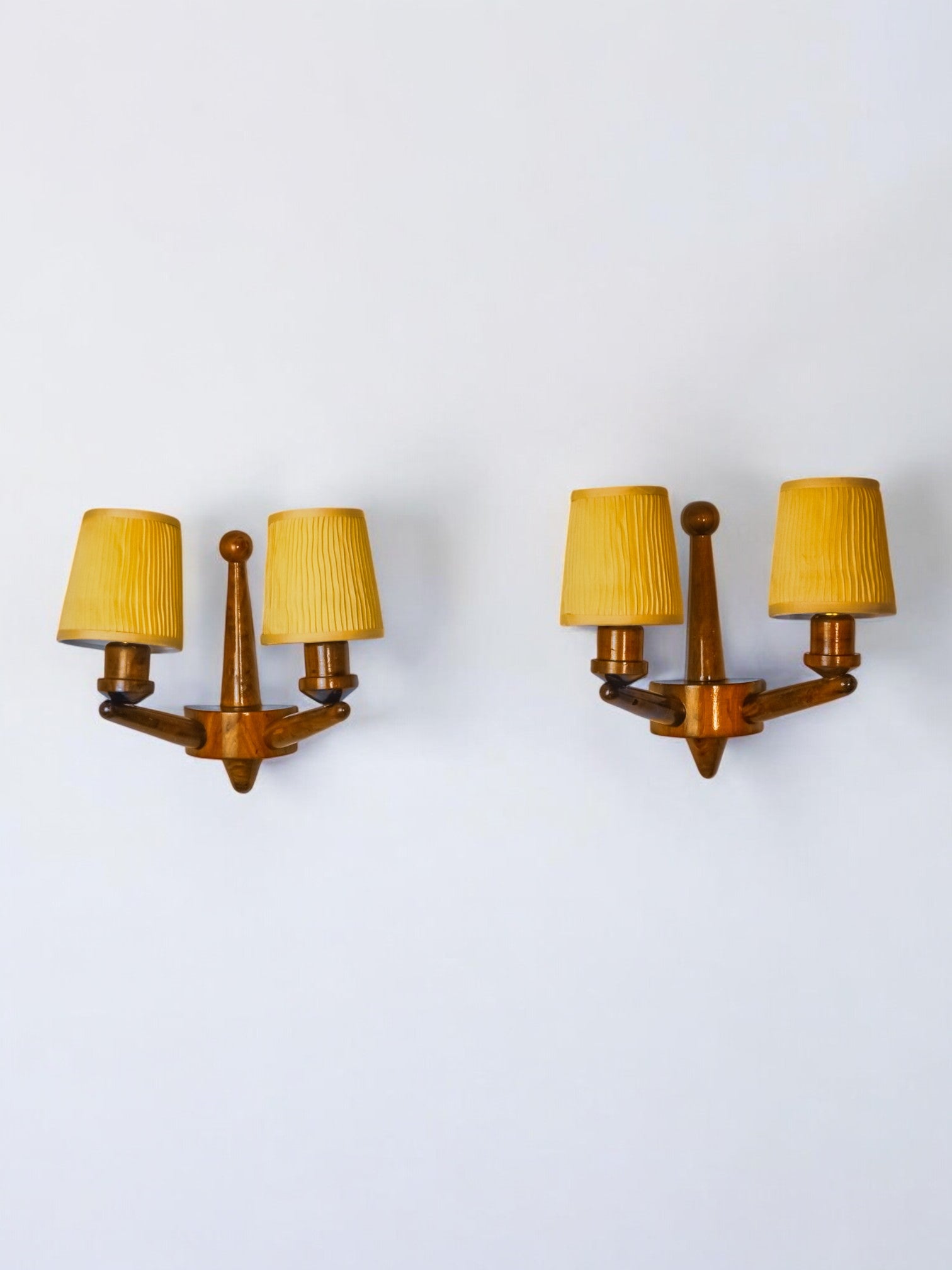 Pair of two-armed art deco "ball" wall lights, carved wood, France, 1960