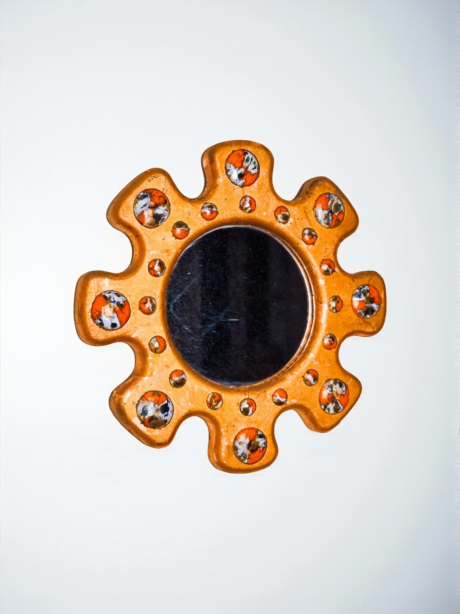 Sun shaped Modernist enamel mirror by J. Capo Esmaltes, Spain, 1970's
