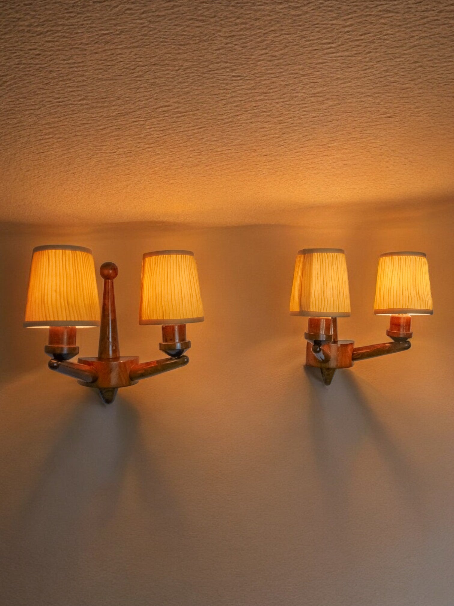 Pair of two-armed art deco "ball" wall lights, carved wood, France, 1960