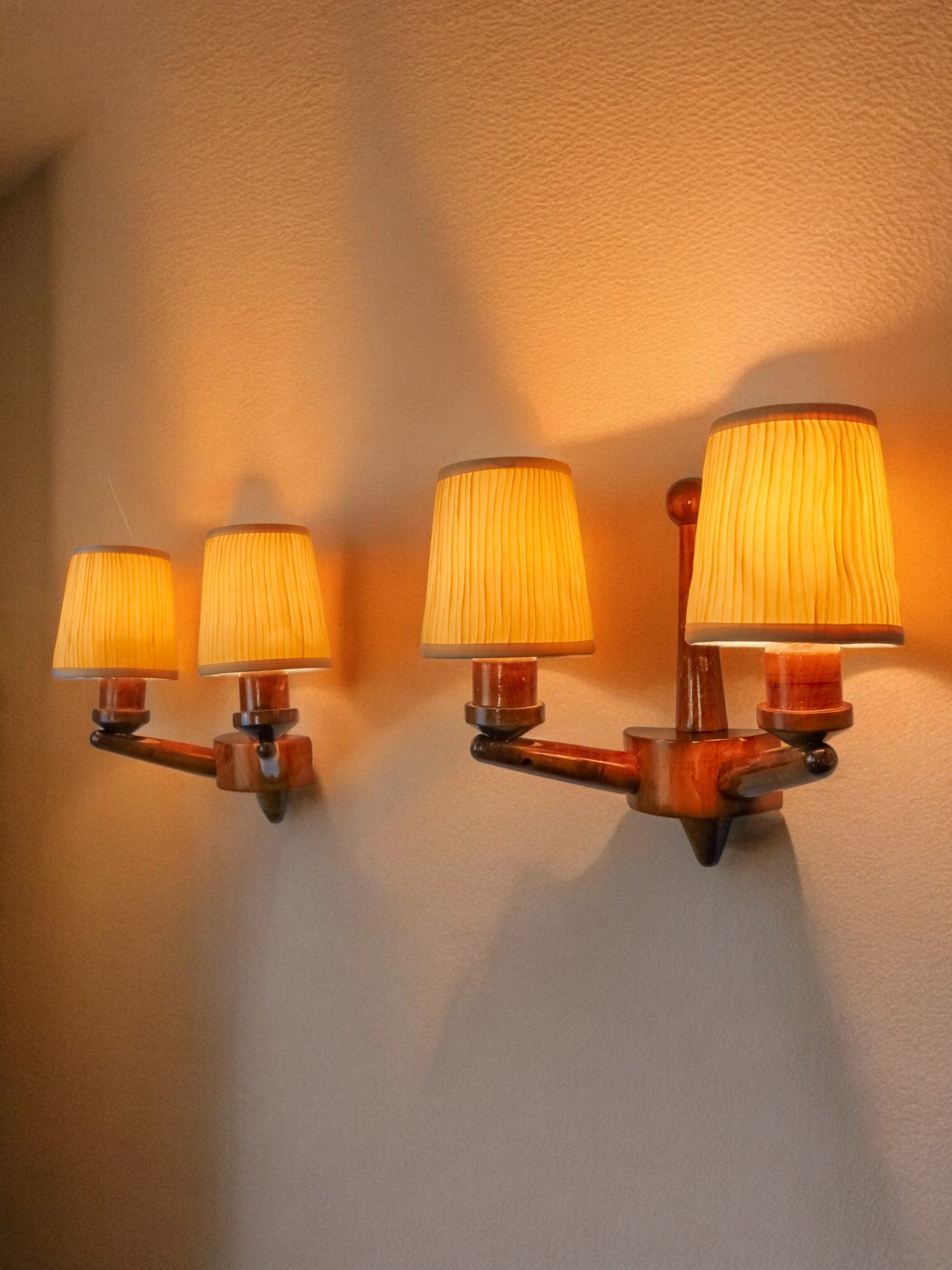 Pair of two-armed art deco "ball" wall lights, carved wood, France, 1960