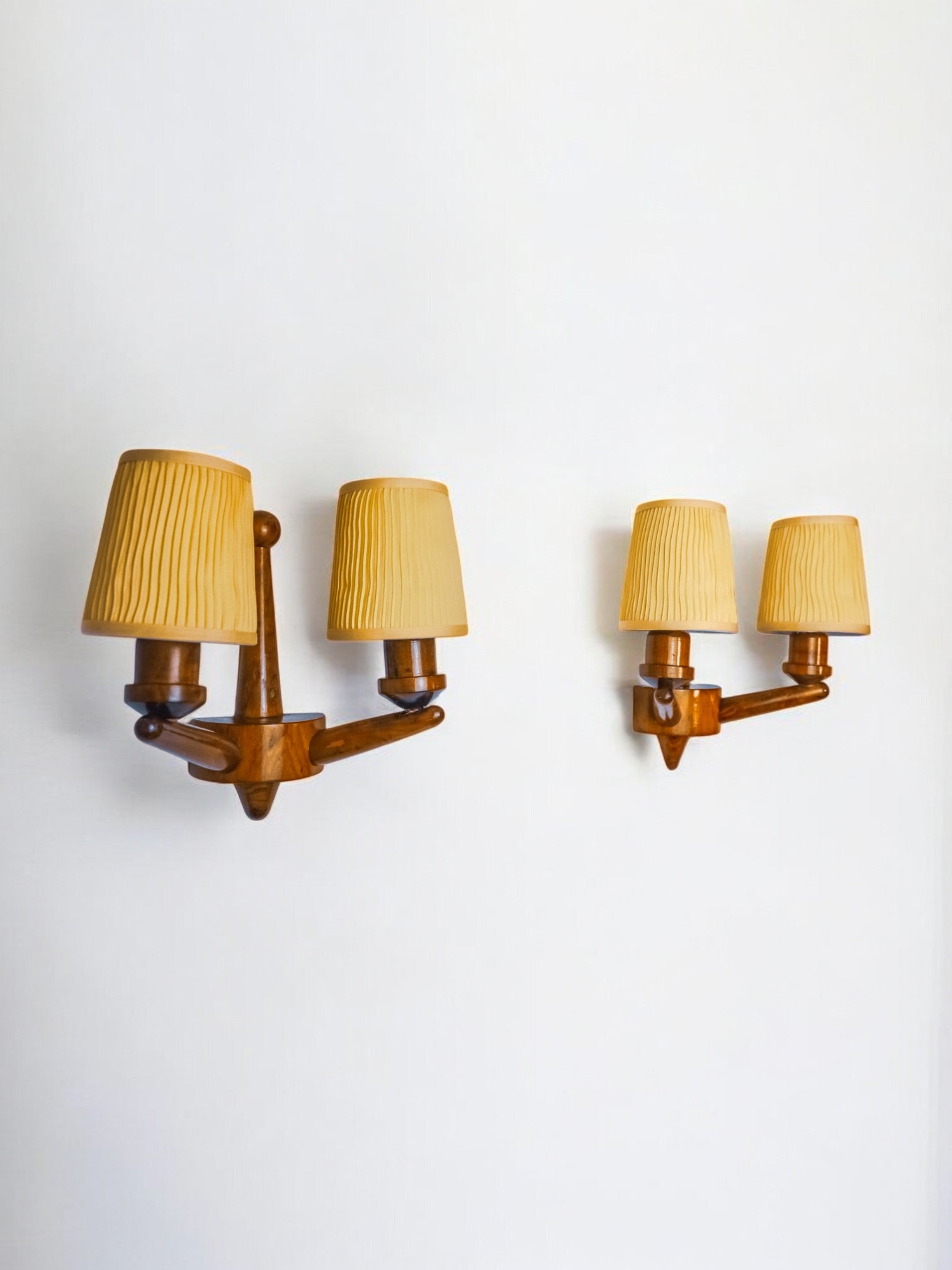 Pair of two-armed art deco "ball" wall lights, carved wood, France, 1960