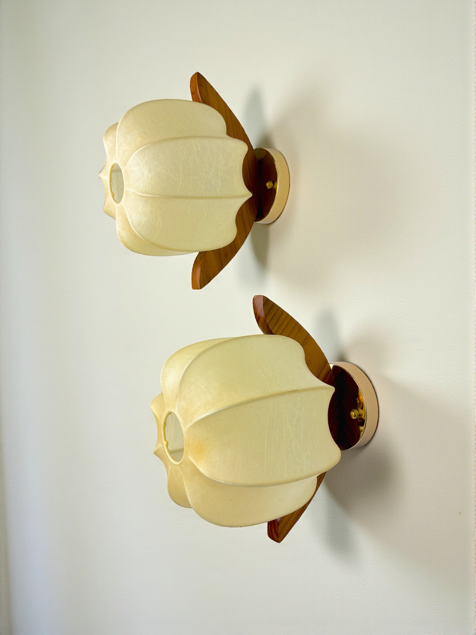 Pair of Italian "Cocoon" wall lights, resin and pine wood, 1970s