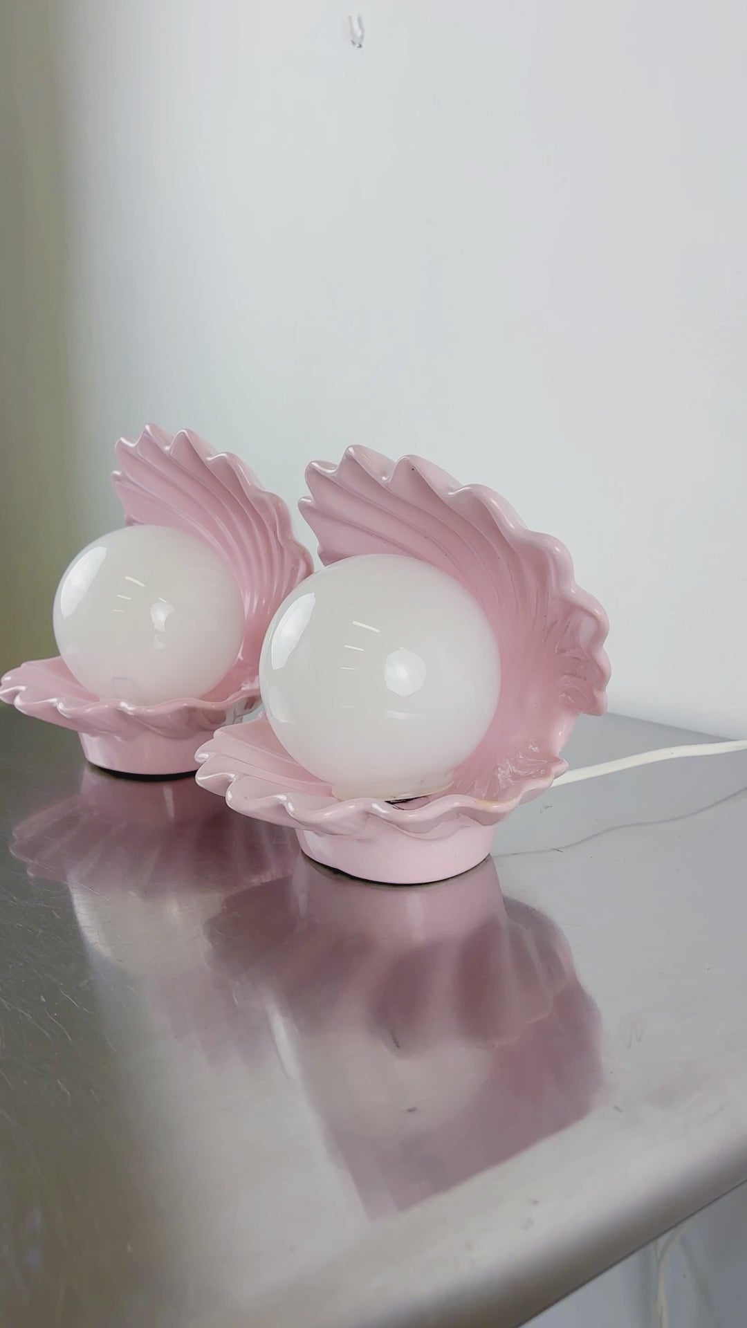Load video: Pair of pink ceramic shell-shaped table lamps, Italy, 1970s